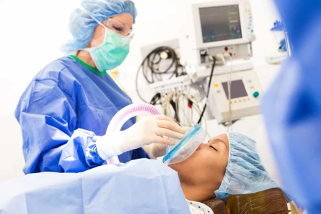 Medical professional administers anesthesia to a patient